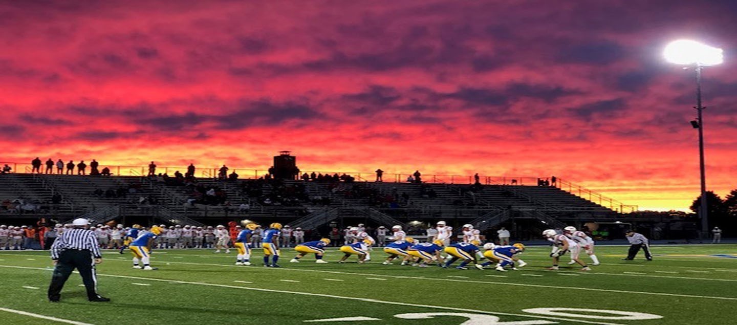 Football game under red sky